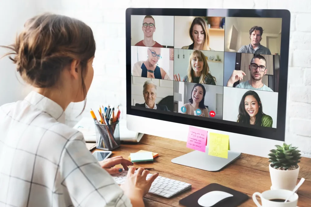 Woman participating in group video conference on desktop