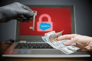 Gloved hand offering key for cash before locked laptop